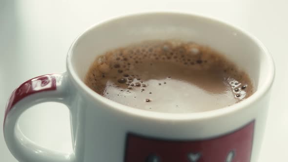 Drops Falling In a Cup of Espresso in Slow Motion.