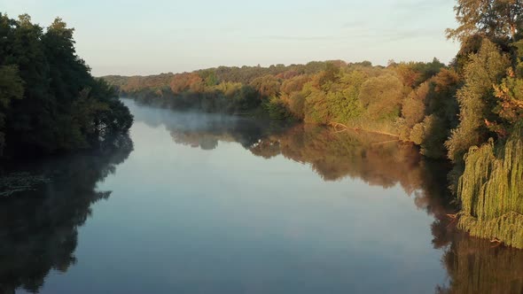 Beautiful morning, summer flight over the river. Fog, trees.