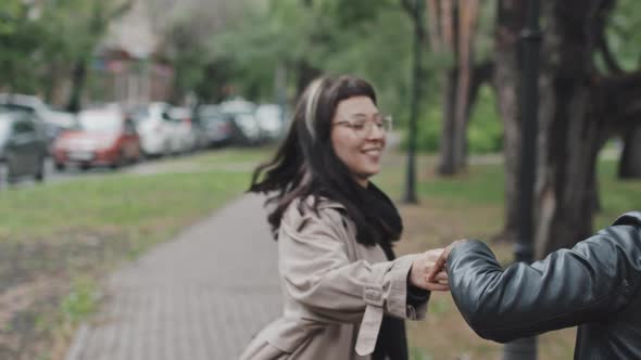 Happy LGBTQ Couple Laughing and Dancing in Park