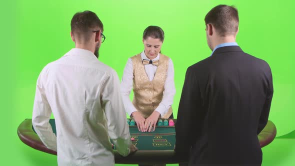 Croupier Woman Handing Out Cards and Chips for Two Players in Poker. Green Screen. Slow Motion