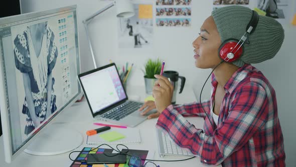 Trendy Worker in Headphones Working