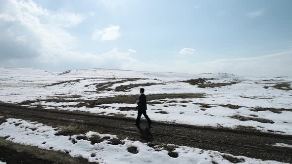 Young Man Walking The Village Road Aerial View