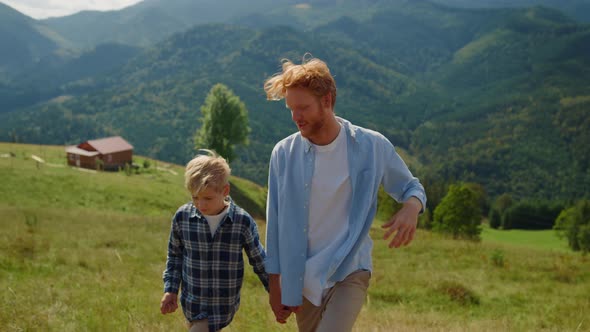 Father Son Talking Outdoors Walking Mountain Slope Closeup