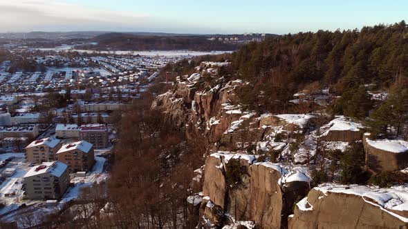 Mountain Wall and Residential Dwellings and Apartments  Winter Aerial Rising