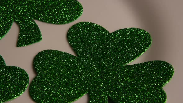 Rotating stock footage shot of St Patty's Day clovers on a white surface - ST PATTYS 006
