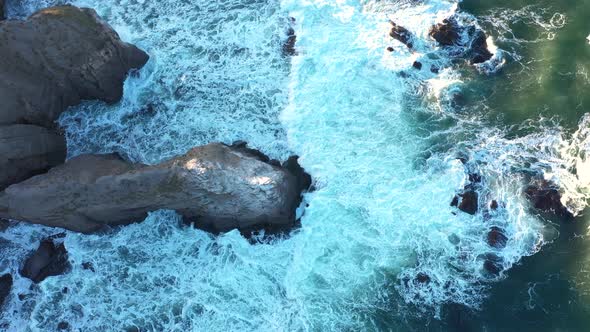 Aerial view to a beautiful wild rocky beach and big waves