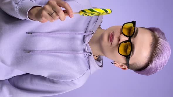 Vertical Shot of Young Woman Licking Lollipop Eating Candy Pleasure