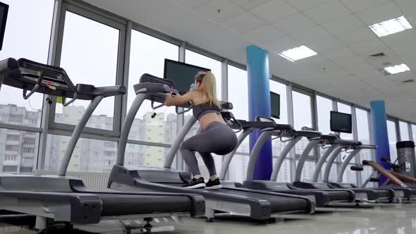 Young sporty Woman On Running Machine In Gym