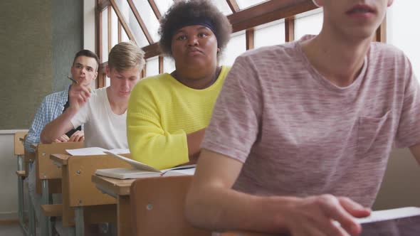 Student raising his hand in class