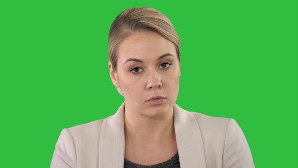 Young anchorwoman making announcements on a Green Screen