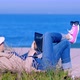 Woman Lying on Sand and Chatting Online on Beach - VideoHive Item for Sale