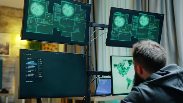 Zoom in Shot of Male Hacker Trying To Hack a Firewall
