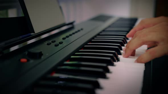 A Man Plays Music on a Keyboard Instrument