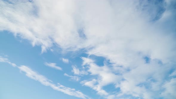 Timelapse of Clouds move across the sunny sky