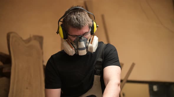 Close-up of a carpenter who works in a workshop