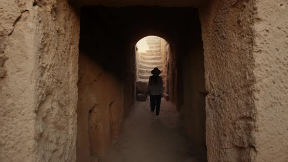 Female Archeologist Walking Among Ancient Temple