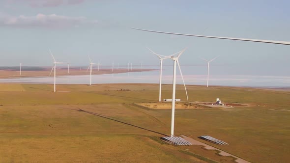 Aerial Drone View To Large Wind Turbines in Field. Alternative Energy