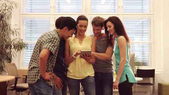 Group of business executives discussing over digital tablet