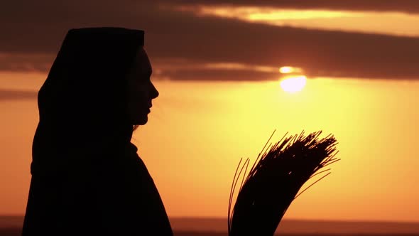 Profile Girl in Fancy Dress Witch Holds a Broom Sunrise Outdoors