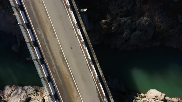 empty bridge and road top view, rocky coast