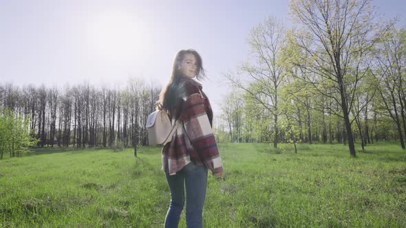 Beautiful Young Woman Walks in Nature