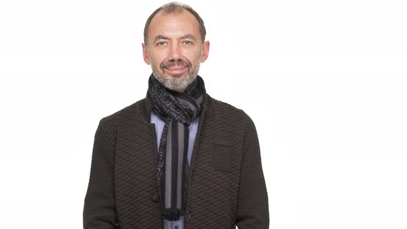 Portrait of Middleaged Mustached Gentleman with Grey Beard Smiling on Camera with Smart Look Over