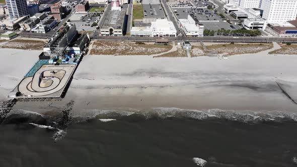 A side profileing aerial view of the Atlantic City beach and shoreline.