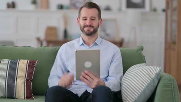 Video Chat on Tablet By Young Man at Home