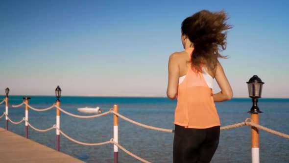 The Beautiful Girl Runs Along at Sunset