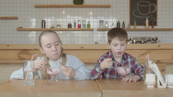 Cheerful Preteen Kids Eating Ice Cream in Cafe alt