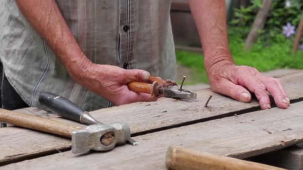 Old Man Repairing a Fence.