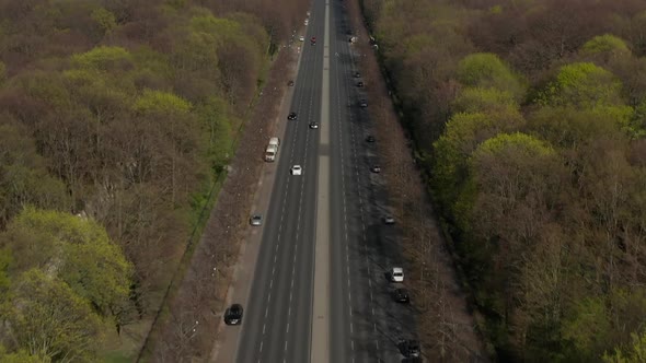 AERIAL: Strasse Des 17. Juni with Pan Up To Reveal Brandenburg Gate in Berlin, Germany on Sunny Day