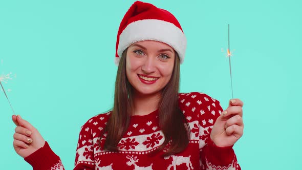 Lovely Girl in Christmas Santa Sweater Dancing with Bengal Sparklers Fireworks Ligts Congratulation
