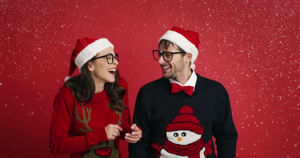 Playful couple are excited from Christmas snow