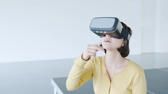 Woman weraing VR headset in a modern office