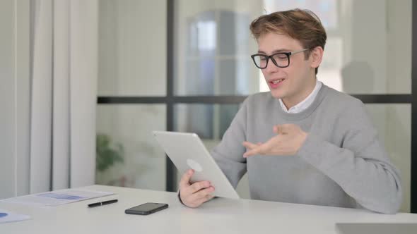 Young Man Making Video Chaton Tablet in Modern Office