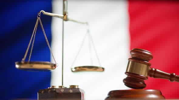 A Judge Gavel with a Flag of France on Background