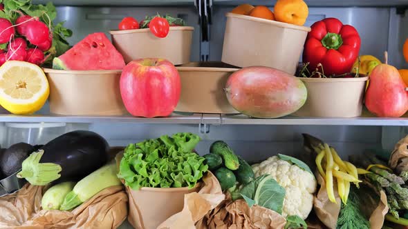 Opened refrigerator full of vegetarian healthy fruit, vegetables in zero waste boxes