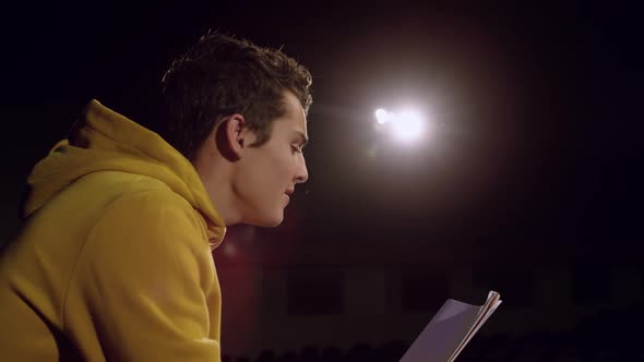 Teenagers rehearsing in a theatre alt