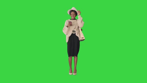 Pretty African American Woman Knitted Sweater White Hat Answering Her Phone Green Screen Chroma Key