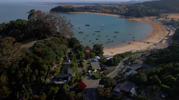 Aerial view of houses and boats in Tasman sea bay in Kaiteriteri, New Zealand