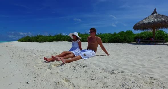 Beautiful boy and girl after marriage in love have fun on beach on summer white sandy background