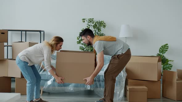 Man and Woman Carrying Heavy Boxes To New House and Suffering From Backache Feeling Bad