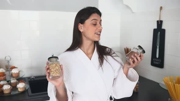 Beautiful Smiling Girl Dressed in White Bathrobe Preparing Breakfast