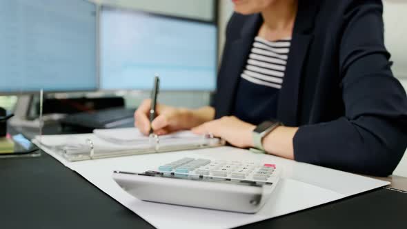 Close Up View of Woman Accountant Working Using Calculator