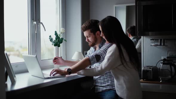 Young Couple Checks Their Loan or Mortgage Documents