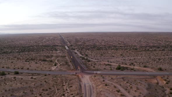 Aerial pull-back of an intersection in an Arizona desert at golden hour