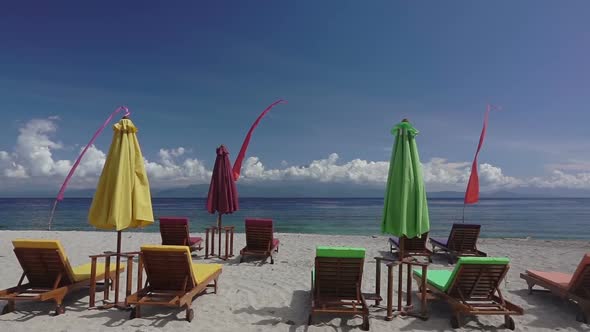 Empty Sunbeds and Umbrellas on the Beach