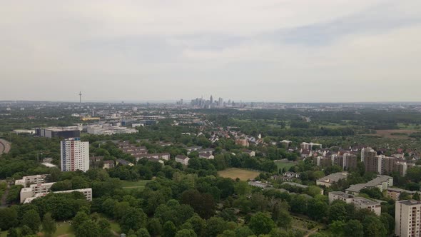 Aerial approach towards the cityscape of Frankfurt, Germany on an overcast spring day. Wide angle tr