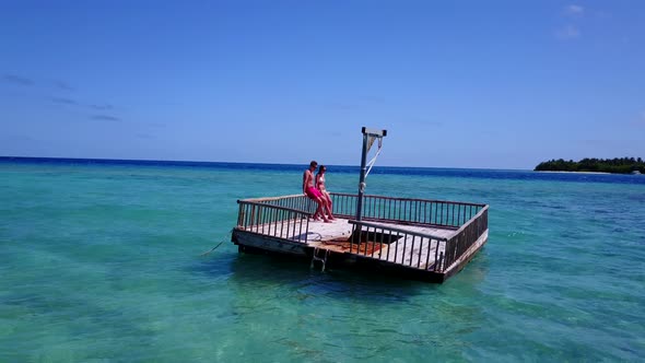 Beautiful couple on honeymoon vacation enjoy luxury on beach on clean white sand background